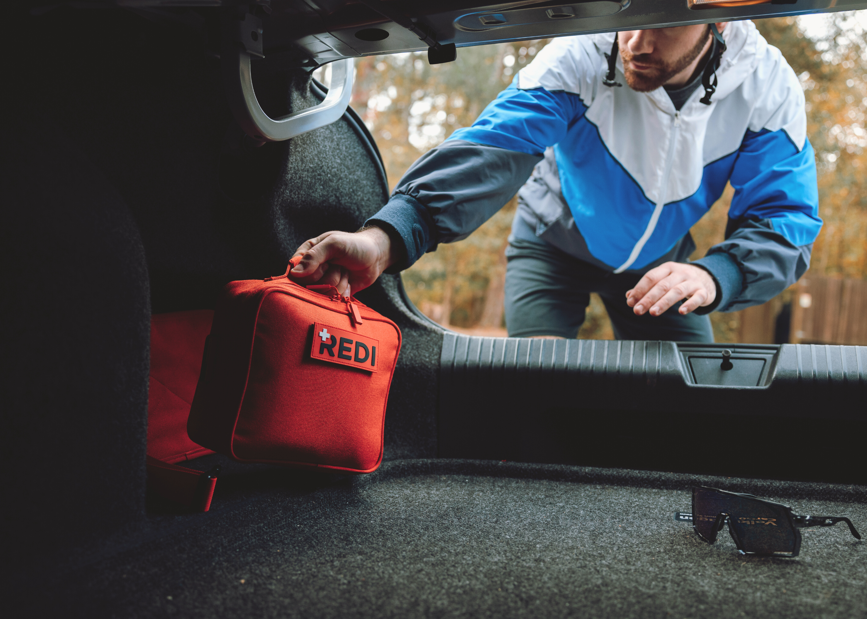 Man pulling Roadie kit out of his car trunk.