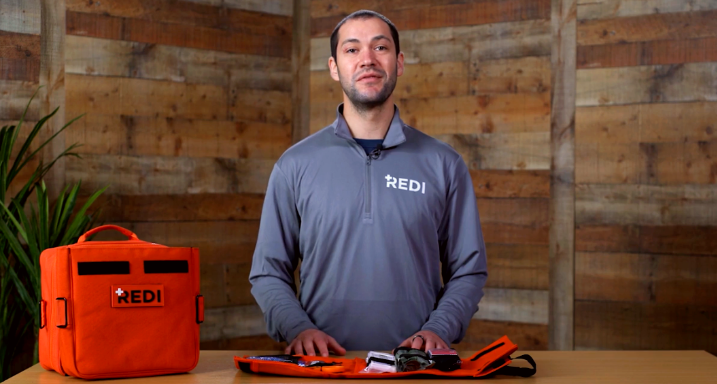 Redi Instructor, Gavin Dawson, standing with the Roadie Pro, quick release trauma pack open in front of him.